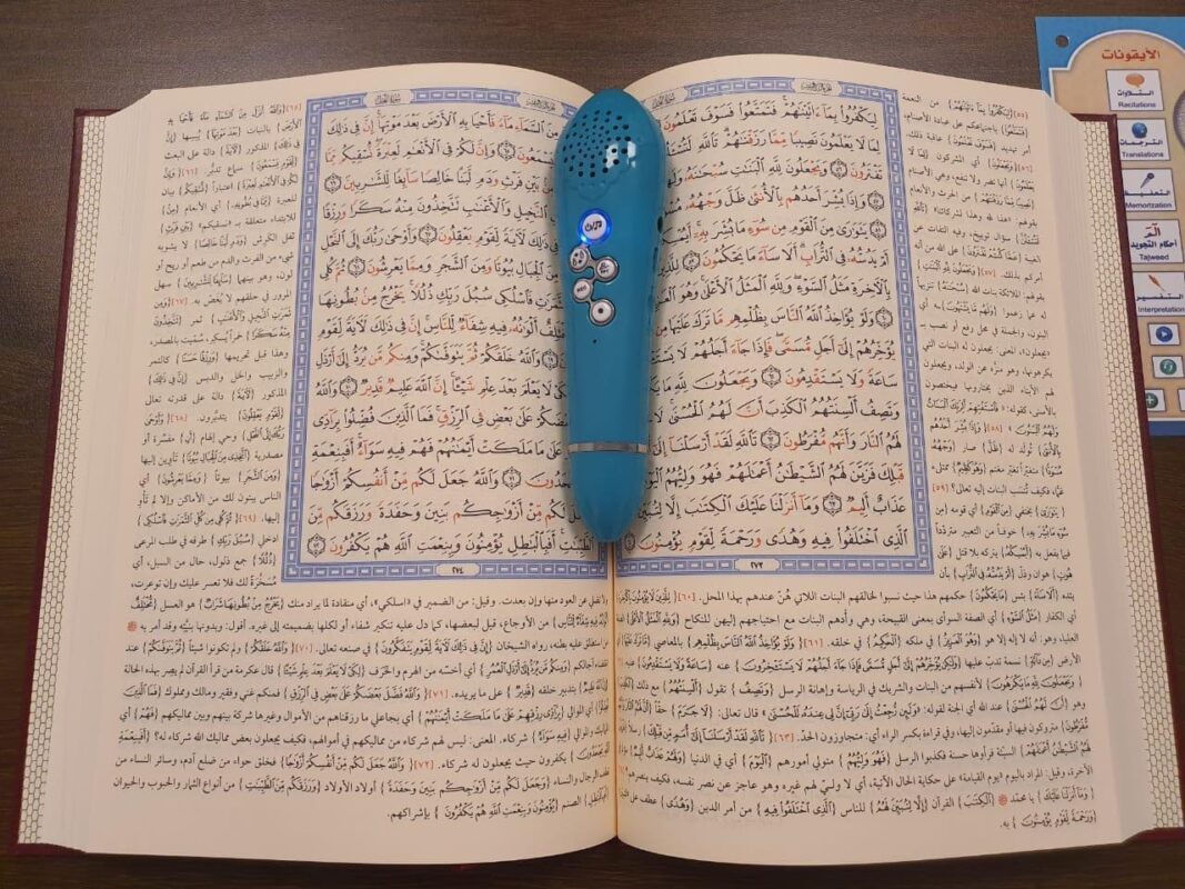 Talking Quran set with digital pen enabling instant audio playback for Quran reading and learning